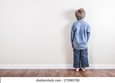 Boy standing up against a wall - Shutterstock ID 171985700