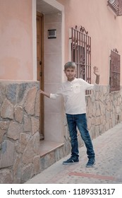 Boy Standing Near Door, Waving Goodbye To Friends And Go Home.