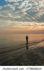A boy standing on the beach