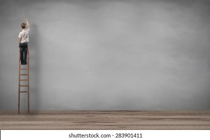 Boy Standing On Staircase And Writing In The Wall