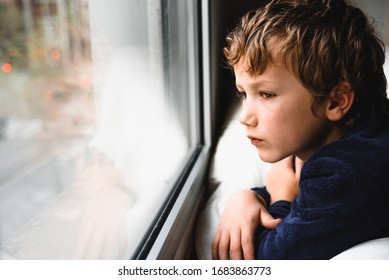 Boy stays home bored by school closings due to covid pandemic. - Shutterstock ID 1683863773