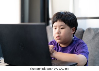 A boy stays home and studying online with tablet in house.