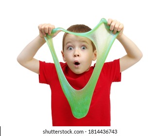Boy stretches slime toy in hands and looks through it. Kid playing on a white background