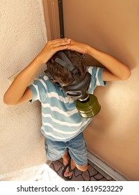 Boy In Striped Shirt Wearing Gas Mask At An Apartment Complex. Image Can Be Used For Air Pollution, Second Hand Smoke ,or Asthma