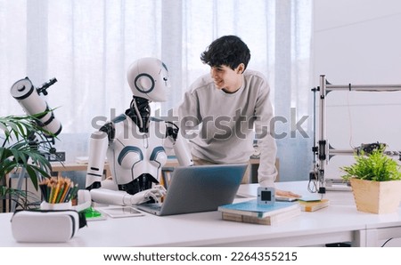 A Boy studies with the help of a Robot. The result is fruitful. Robot and Human Collaboration Concept.