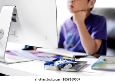 Boy Studying Mathematics Virtual Class Through Online Learning In Front Of Computer. Kids Stay At Home And Attend Online Classroom During Covid-19 Pandemic. Education And The New Norm Background.