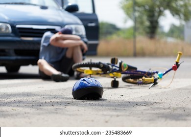 A Boy Suffering After A Bike Accident With A Car