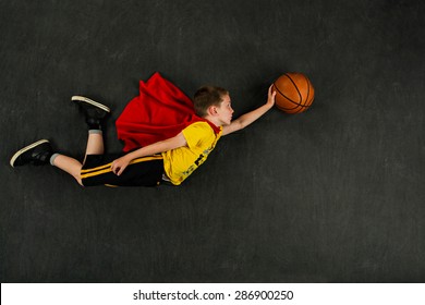Boy superhero with a basketball