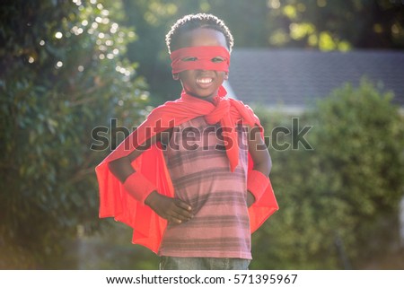 Boy in a superhero costume in a park