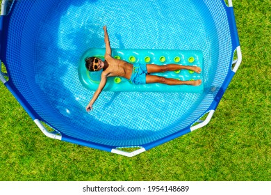 Boy swim on inflatable matrass view from above - Powered by Shutterstock