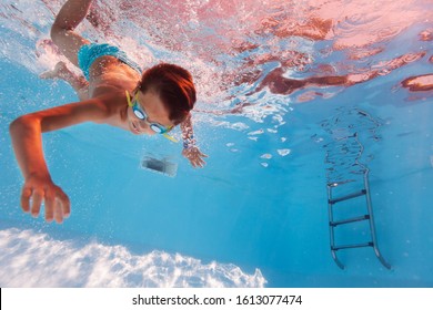 Boy Swim Underwater In The Pool Wearing Googles