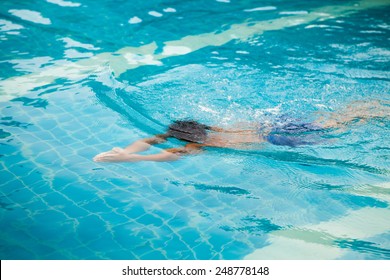 Boy Swimming In Breaststroke Underwater.