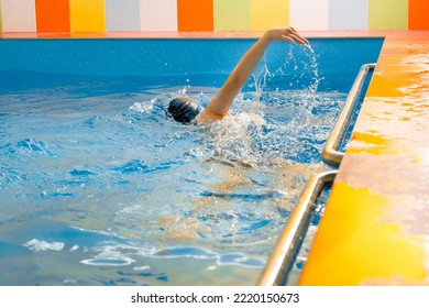 Boy Swimming In Indoor Pool Having Fun During Swim Class