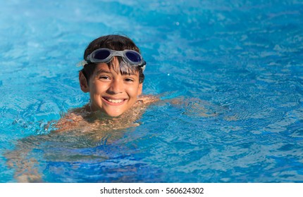 Boy Swimming And Playing In A Pool