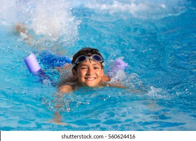 Boy Swimming And Playing In A Pool