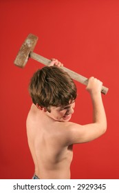 Boy Swinging Sledge Hammer Vertical