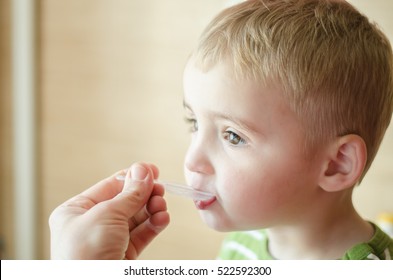 Boy Takes Medicine Syrup