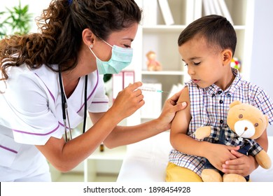 A boy taking a vaccine shot with no fear in his eyes  - Shutterstock ID 1898454928