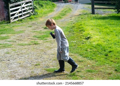 Boy Talking On The Speaker Phone On The Street