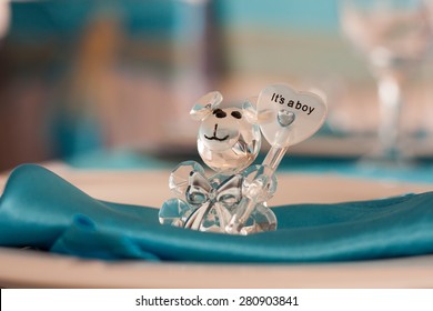 It's a boy . Teddy bear made ??out of glass holding a big heart .