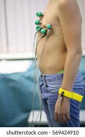 Boy Teen In Jeans Stands With Wires Stick To His Body In Medical Cabinet, Noface