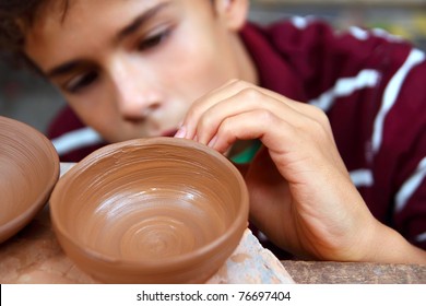 boy teen potter clay bowl working in pottery workshop traditional arts