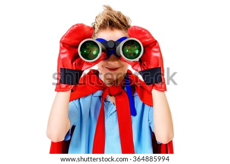 A boy teenager in a costume of superhero looking through binoculars. Isolated over white background.