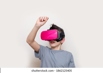 Boy Teenager In Glasses Of Virtual Reality Simulator Receives Online Education Or Plays, Writing On The Virtual Space. Modern Education With The Help Of Digital Technologies. Photo