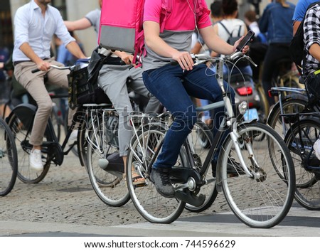boy with thermal bag to bring orderly online shopping and many other bicycles