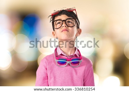 Boy thinking with many glasses