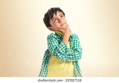 Boy Thinking Over Ocher Background 