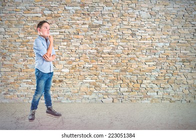 Boy thinking over textured background 