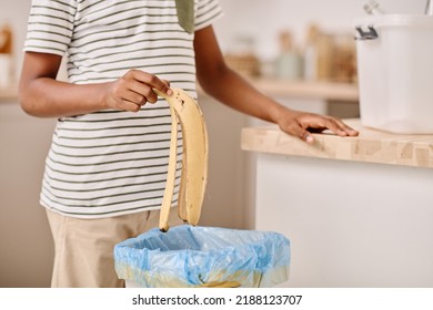 Boy Throwing Banana Peel Into Bucket