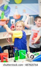 Boy throwing streamers at party