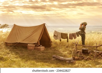 Boy tourist looking into the distance on a high bluff at sunset on a summer evening - Powered by Shutterstock