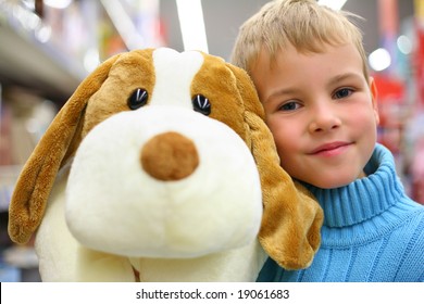 Boy With Toy Dog In Shop