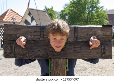 A Boy Trapped In A Medieval Torture Device
