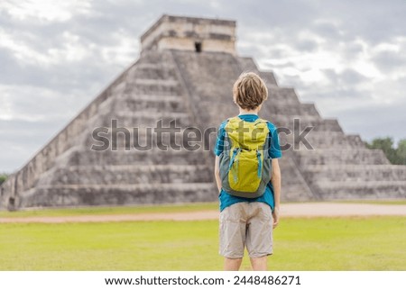 Boy traveler, tourists observing the old pyramid and temple of the castle of the Mayan architecture known as Chichen Itza these are the ruins of this ancient pre-columbian civilization and part of