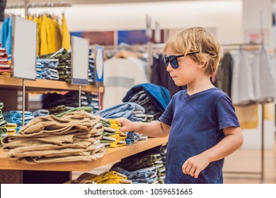 The Boy Tries On Clothes In The Childrens Clothing Store