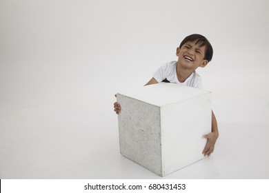 Boy Try Lift A Heavy White Box