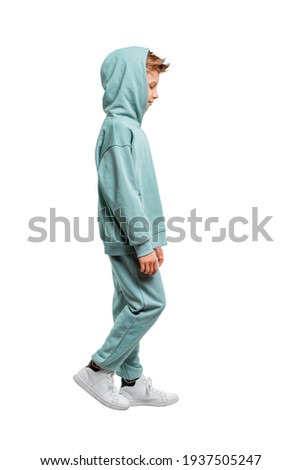boy in a turquoise suit and white sneakers isolated on a white background