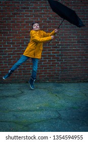 Boy With Umbrella Blown Away By The Storm