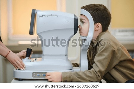 Boy undergoing vision diagnostics with an autorefractor, while an ophthalmologist conducts a thorough eye examination in a clinic setting