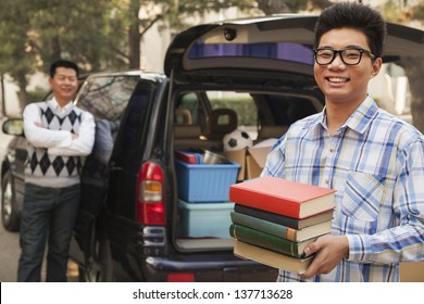 Boy unpacking car for college