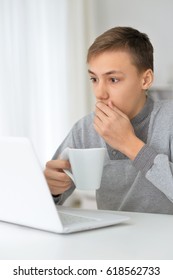 The boy uses the computer