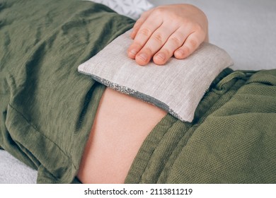 Boy using cherry pits heating pad. Cherry stone thermal pillows, cherry pit filled pillow. Alternative medicine and therapy, pit sack for spa massage, chiropractic care. Selective focus