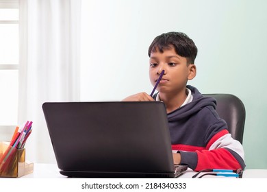 Boy using laptop and doing homework in the living room - Powered by Shutterstock - Get 15% off with code: PIKWIZARD15