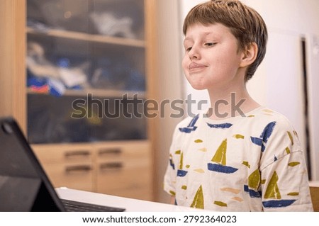 Boy using laptop speech therapy exercises, online education and modern childhood lifestyle, digital learning, happy study time.