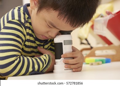 Boy Using Microscope At Home Or Classroom. Curiosity Is The Key Of Successful Learning Experience In Early Childhood Education.