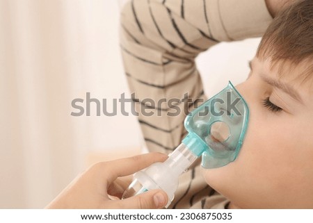 Similar – Image, Stock Photo Cute preteen boy inhales the air of freedom from car window during family road trip and enjoy of pleasant expectation of happy vacation. Joyful child travel with parents